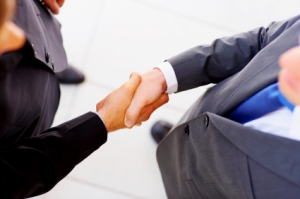 Businesspeople shaking hands, finishing up a meeting.